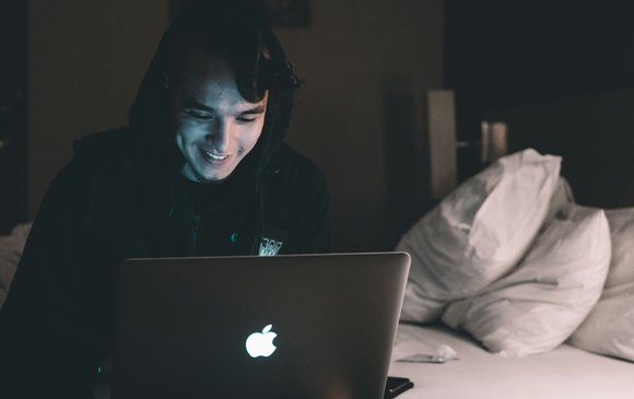 A young person uses a laptop.