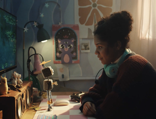 A young person looks at Rusty the Robot.