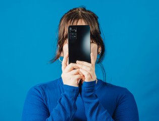 A woman is glued to her phone.