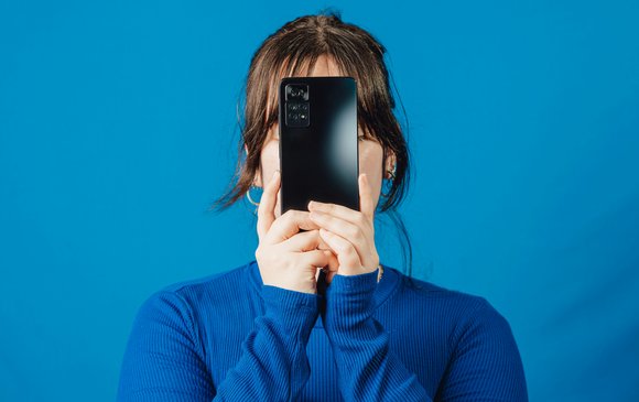 A woman is glued to her phone.